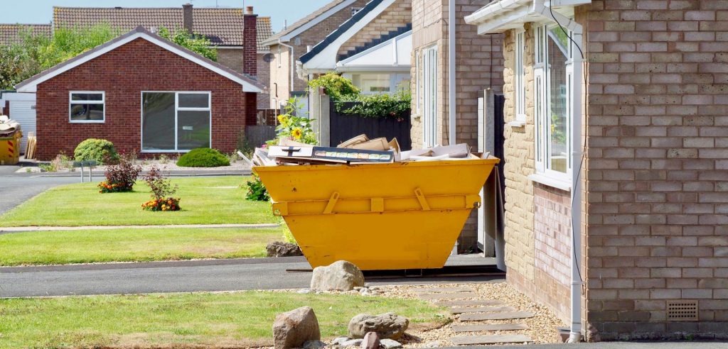 Modern skip on house driveway