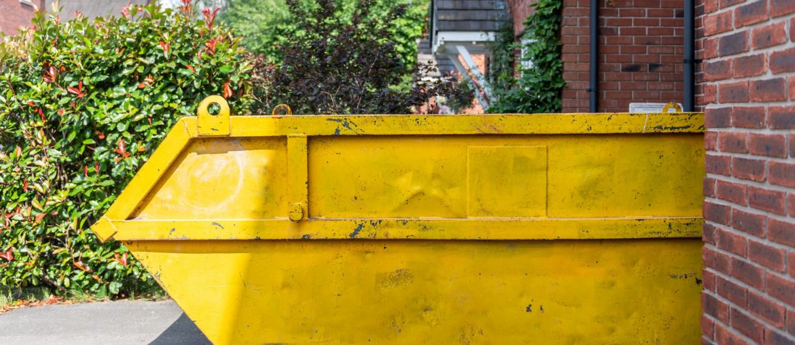 Big Yellow rubbish skip near the house. Rubbish removal hire during renovation of the house