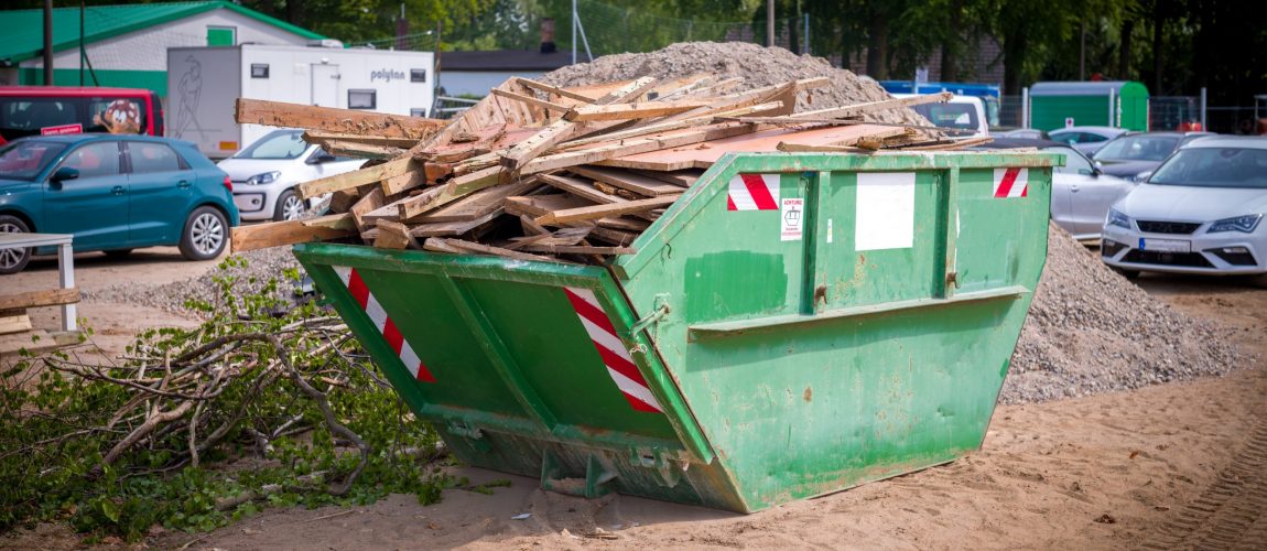 many wood waste is collected on a construction site in a green waste container